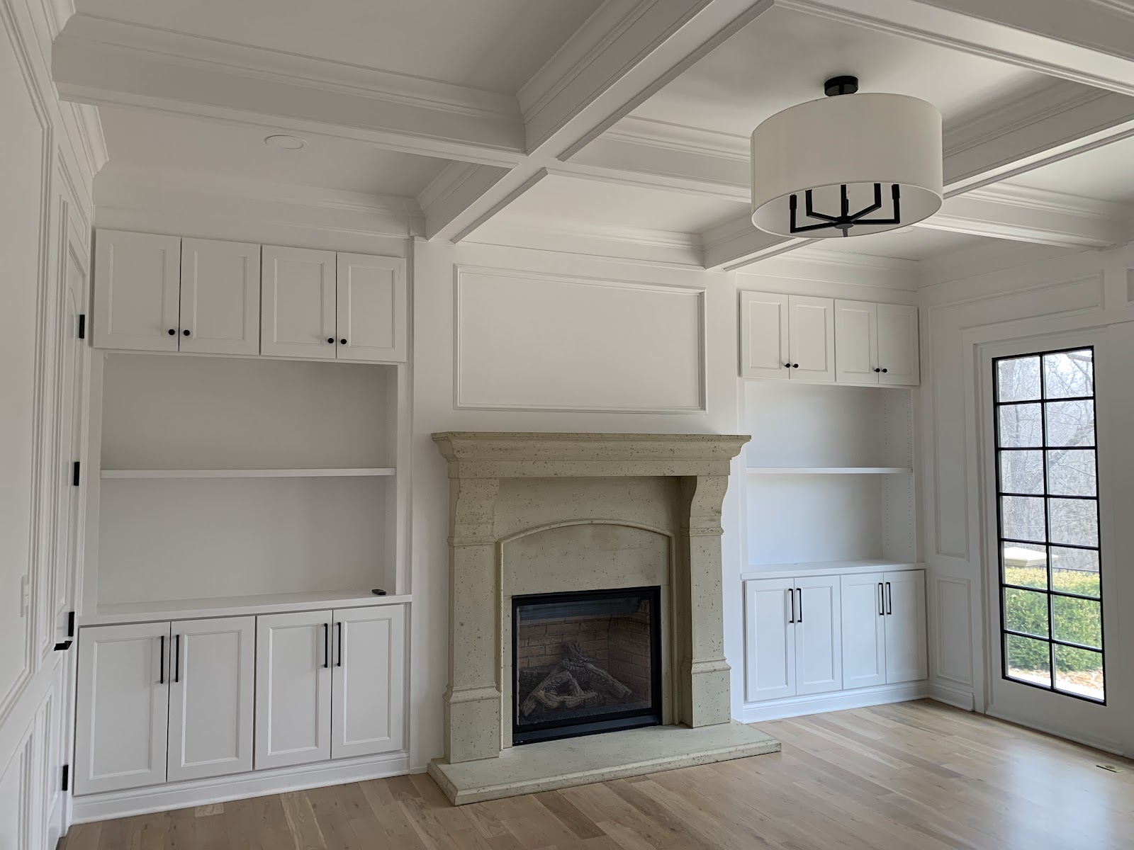 Freshly painted built-ins and trim around a fireplace